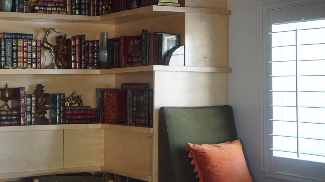 Corner of the custom built-in bookshelves beside a shuttered window, Heber City, Utah